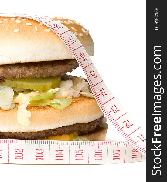 Bread with fried meat, cheese, onion, lettuce and measuring tape isolated on a  white background. Bread with fried meat, cheese, onion, lettuce and measuring tape isolated on a  white background.