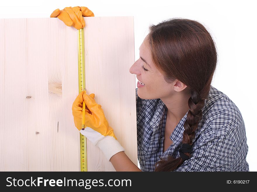 Woman carpenter with wooden plank and measuring tape