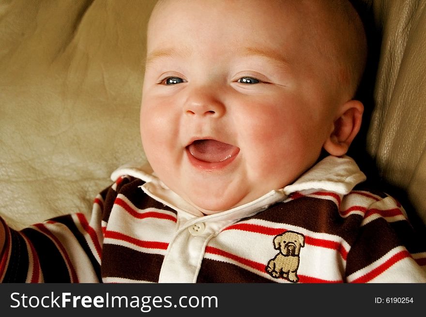 Beautiful, happy baby boy in a cute shirt. Beautiful, happy baby boy in a cute shirt