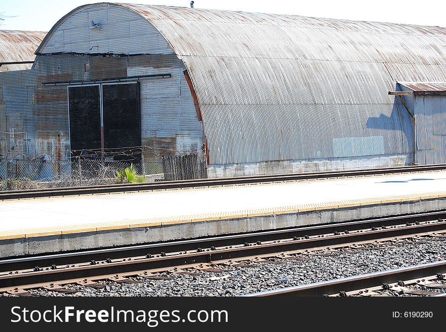 Old, rusty, quonset hut in Martinez, California adjacent to train station