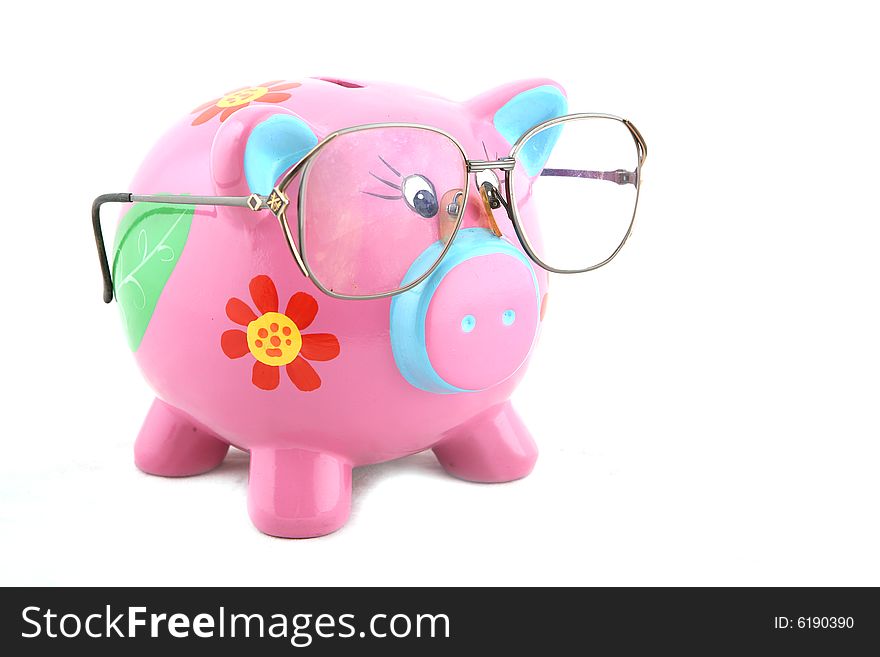 Piggy bank wearing glasses isolated over white. Piggy bank wearing glasses isolated over white