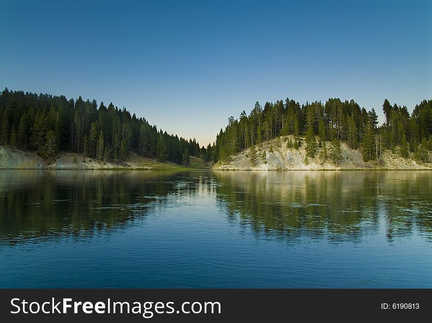Forest reflecting from the Yellowstone River. Forest reflecting from the Yellowstone River.