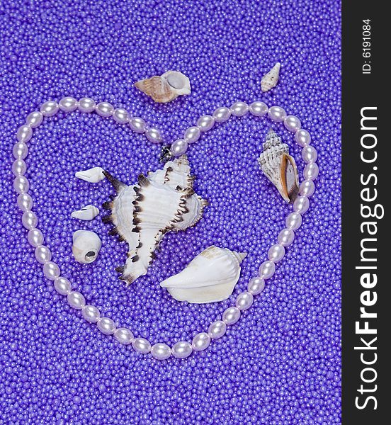 The image heart from pearls beads on a lilac background. The image heart from pearls beads on a lilac background