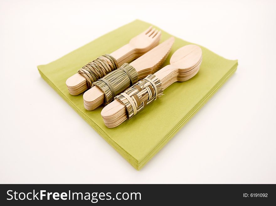 Woods cutlery on a green napkins. Woods cutlery on a green napkins