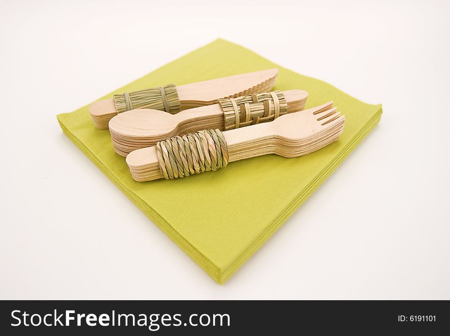 Woods cutlery on a green napkins. Woods cutlery on a green napkins