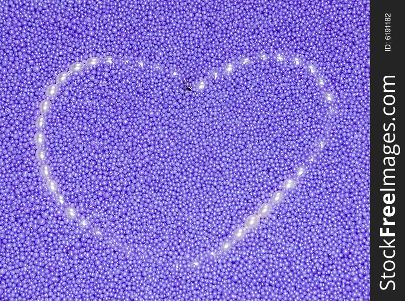 Heart from pearls beads on a lilac background