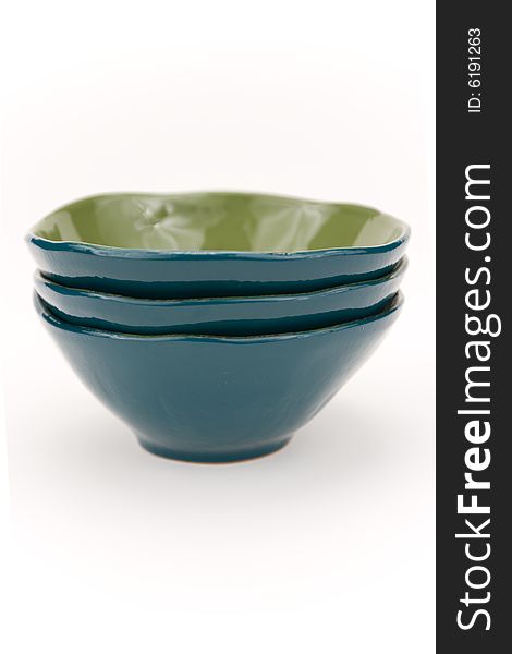 Three turquoise glass bowls on a white backgrounds. Three turquoise glass bowls on a white backgrounds