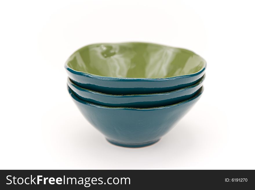 Three turquoise glass bowls on a white backgrounds. Three turquoise glass bowls on a white backgrounds