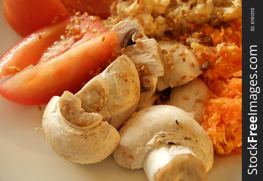 Prepared mixed vegetables on a white platter with hummus and mixed seeds. Prepared mixed vegetables on a white platter with hummus and mixed seeds.