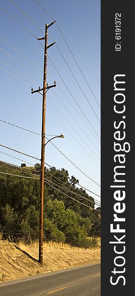 An electric pole that is found in a field. An electric pole that is found in a field.