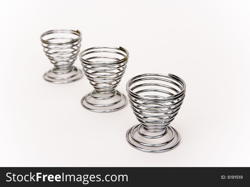 Three silver eggs holder on a white background. Three silver eggs holder on a white background