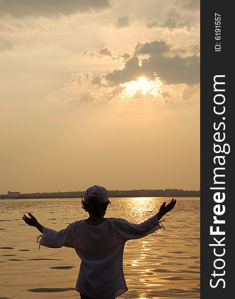 Happy kid on sunset background