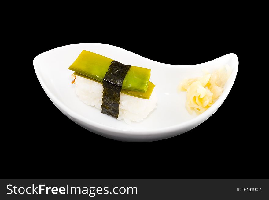 A white plate with a piece of sushi