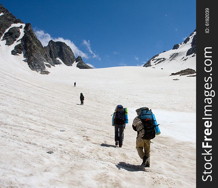 Group of mountain-climber going up to snow pass. Group of mountain-climber going up to snow pass