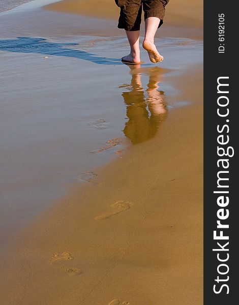 Man walking along the sandy beach. Crete. Greece. Man walking along the sandy beach. Crete. Greece