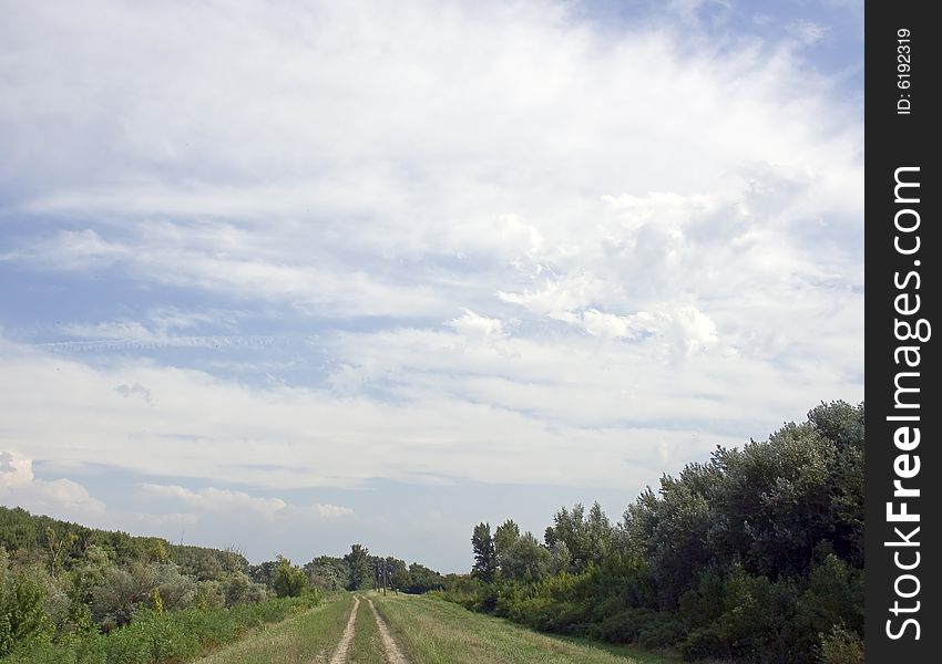 Dirty pathway on meadow and white clouds. Dirty pathway on meadow and white clouds.