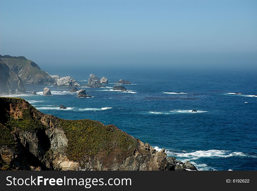 California coastline with blue water and rocky shore. California coastline with blue water and rocky shore