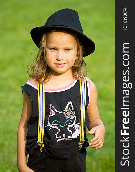 Closeup portrait of little girl on green grass background. Closeup portrait of little girl on green grass background