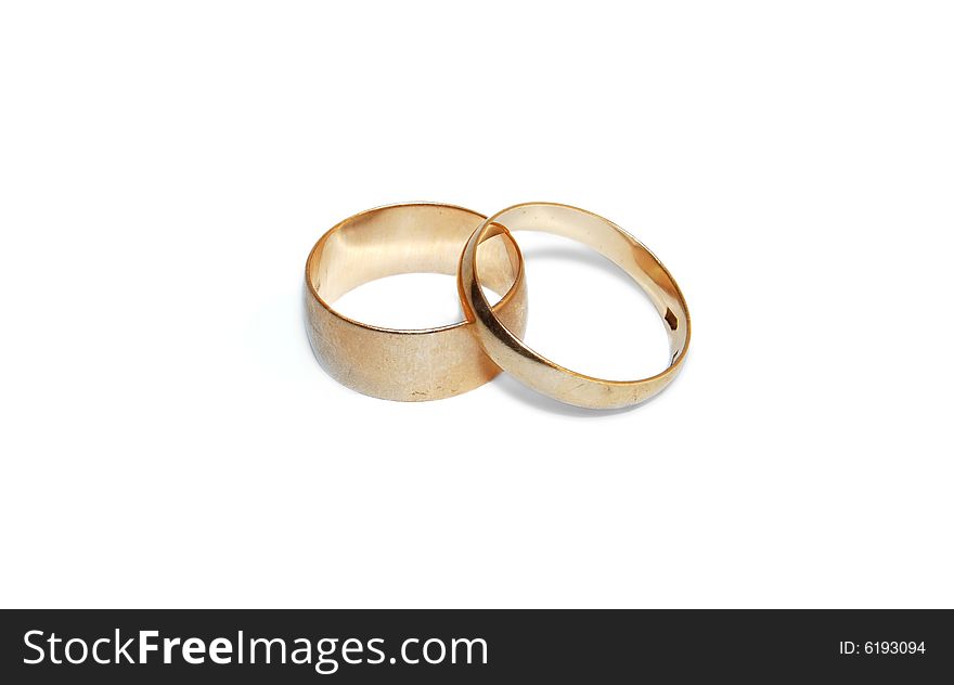 Two wedding rings are isolated on a white background.