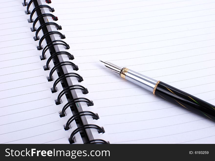 Pen and notebook , isolated in white background.