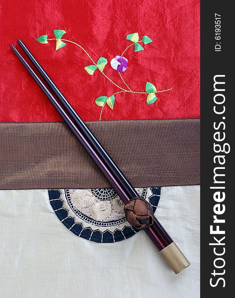 Chopsticks on a Chinese style table cloth. Chopsticks on a Chinese style table cloth
