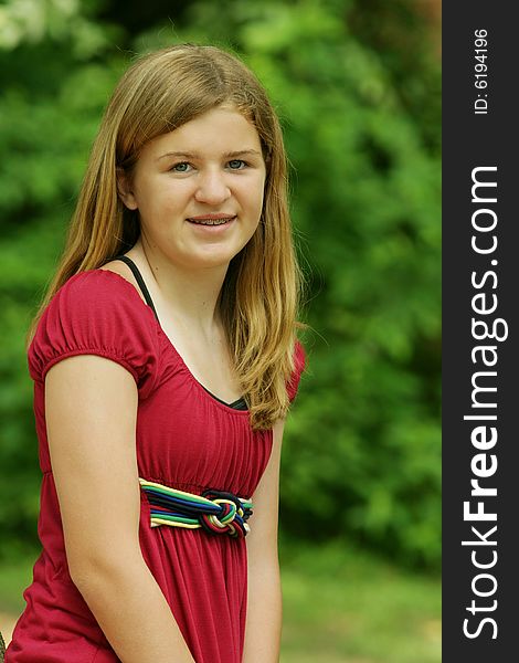 Teenage Girl posing outside in red shirt