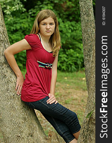 Teenage Girl posing outside in red shirt