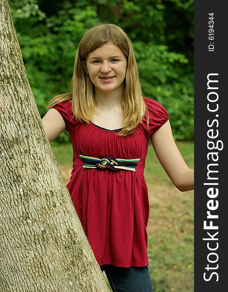 Teenage Girl posing outside in red shirt