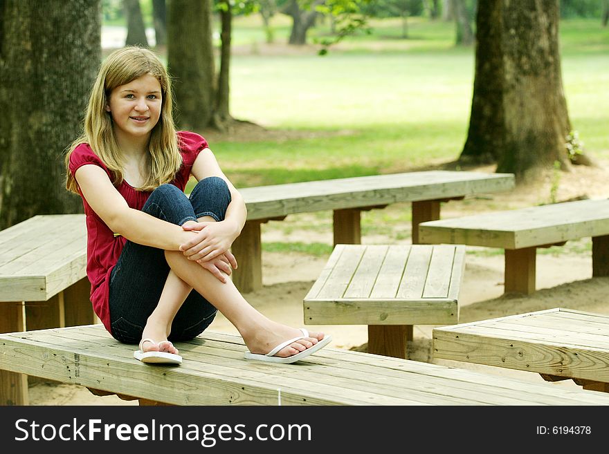 Teenage Girl posing outside in red shirt