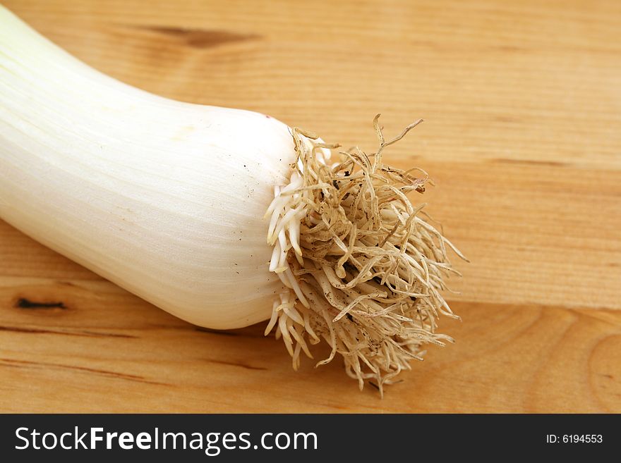 Leek on wooden kitchen board