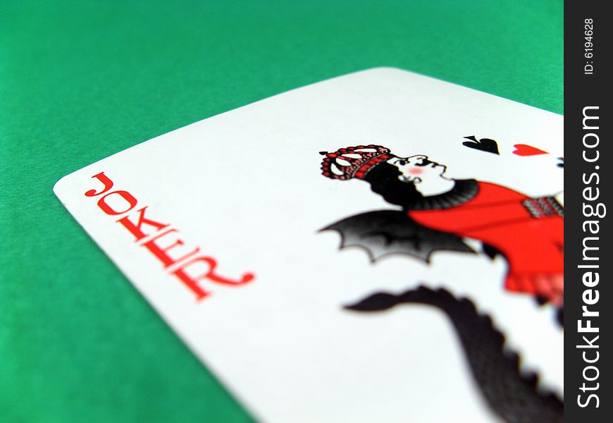 Joker fun poker gambling lucky card on green table