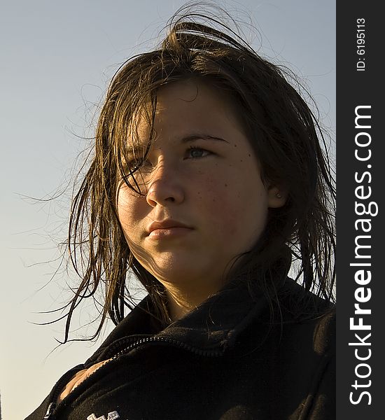 Young Girl/ Teenager half lit face by sunset. Wet hair. Young Girl/ Teenager half lit face by sunset. Wet hair.