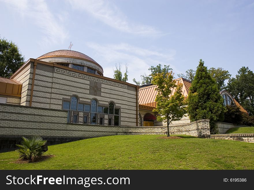 A modern greek orthodox church under blue skies