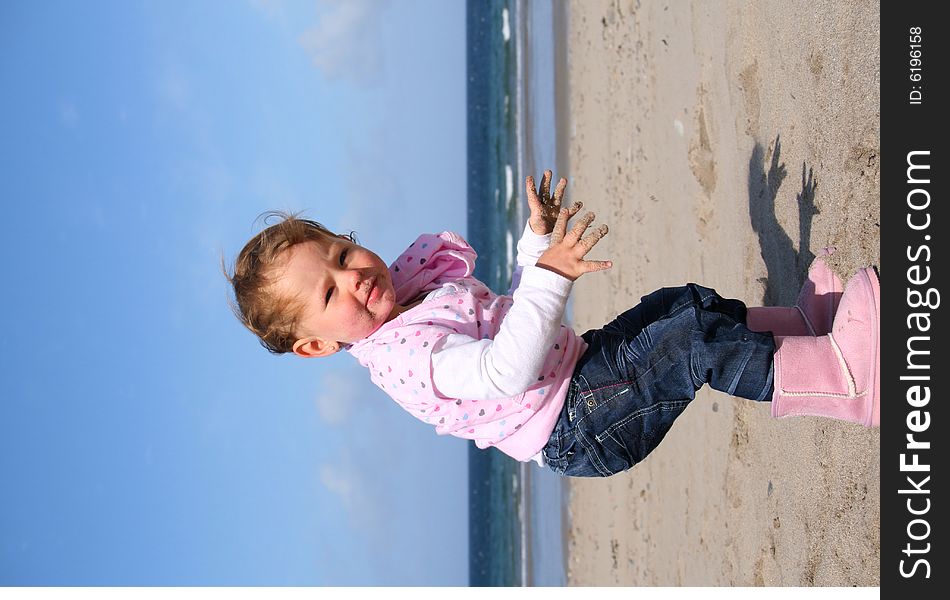 Little girl aged 18 months on the beach exploring the big new world. Little girl aged 18 months on the beach exploring the big new world.