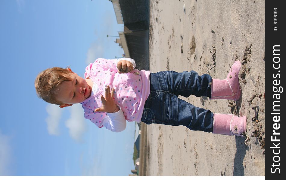 Little girl aged 18 months on the beach exploring the big new world. Little girl aged 18 months on the beach exploring the big new world.