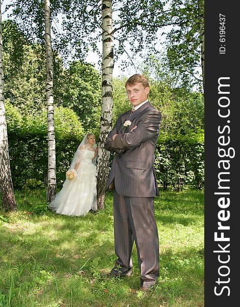 The groom and the bride during walk in park