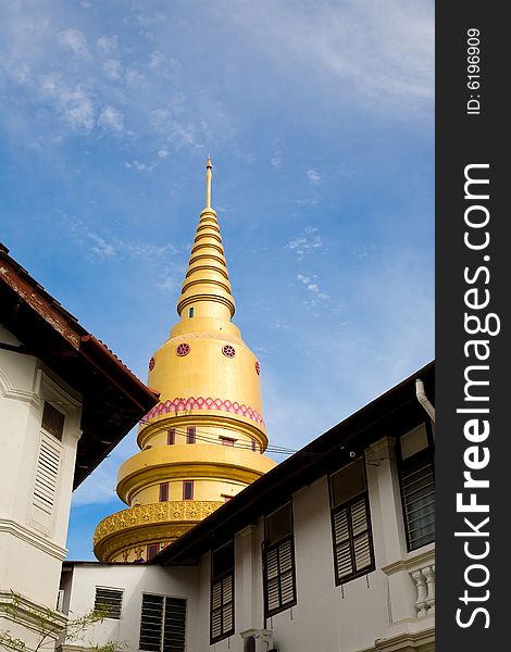 Golden Buddhist Temple architecture against blue sky