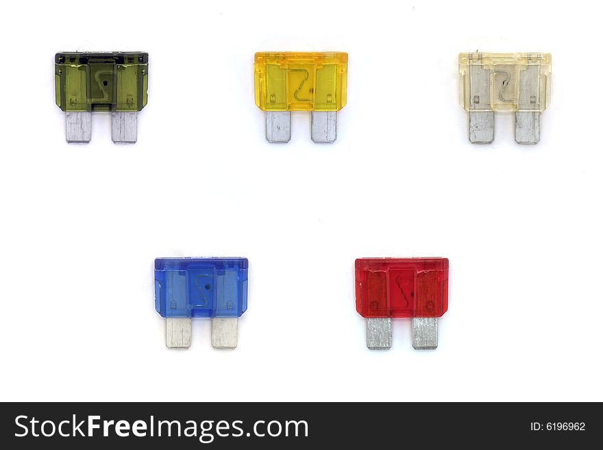 A studio isolated shot of a collection of automobile fuses.