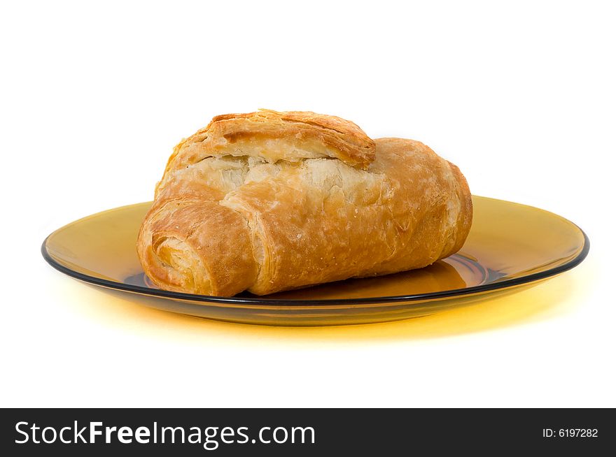 One isolated fresh croissant on plate