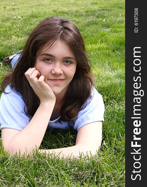 Teen girl in grass smiling