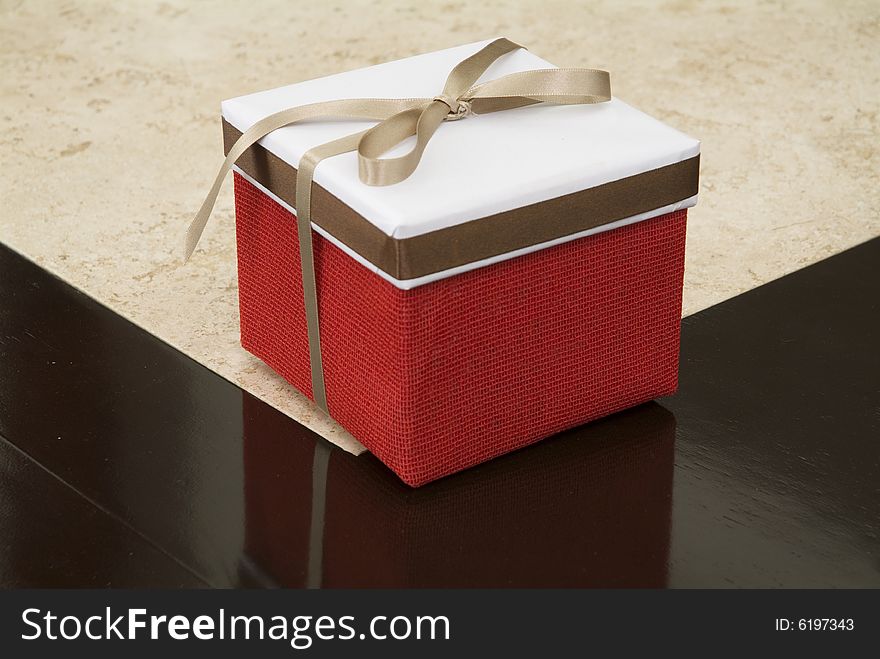 A red gift box in a table. A red gift box in a table