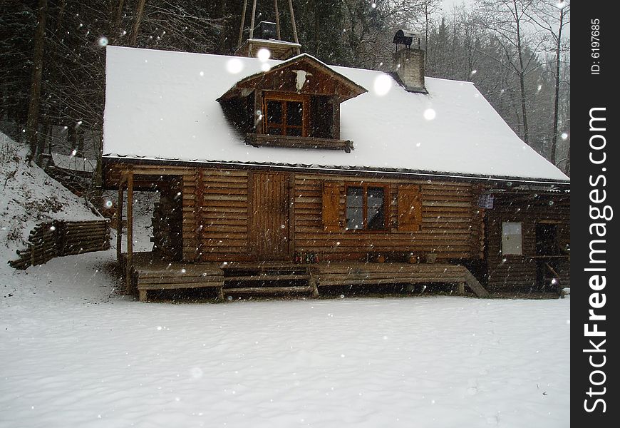 Shack in winter, it is snowing