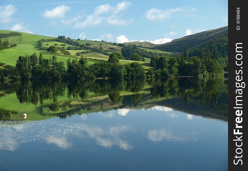 Reflection of fields and medowes on lake vyrnwy