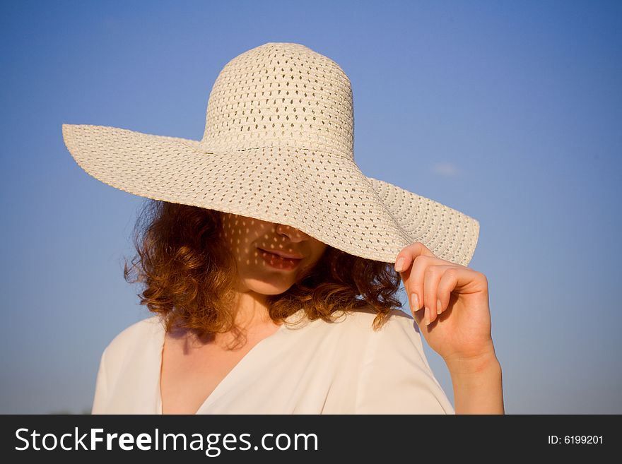 Girl dressed in hat on blue sky