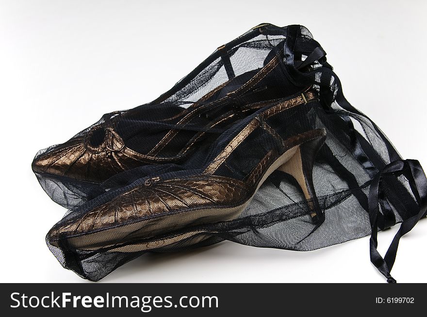 Designer shoes in storage net - closeup