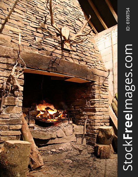 Inglenook fire with antlers and logs