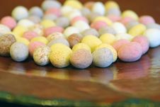 Mini Candy Chocolate Eggs On A Large Brown Dish Stock Photo