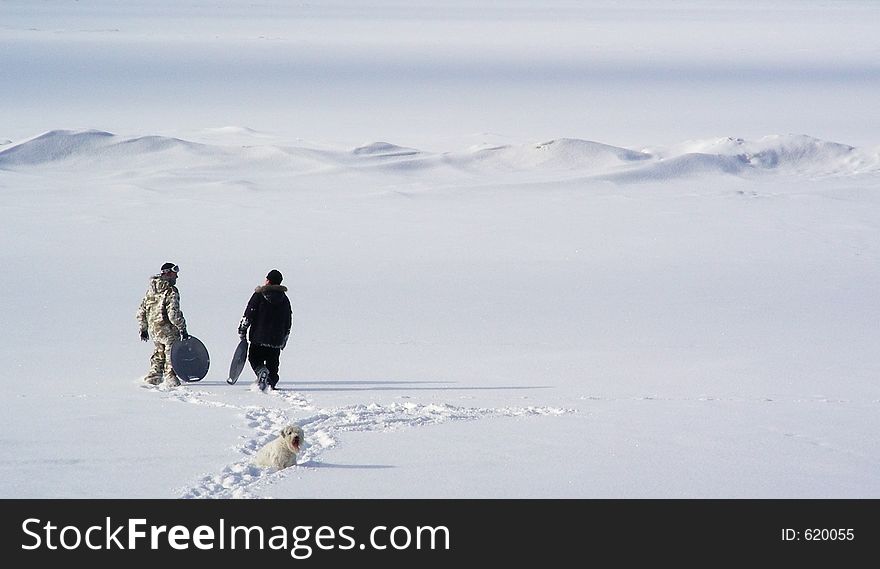 Two boys walking on inocent snow covering Baltic sea. Two boys walking on inocent snow covering Baltic sea