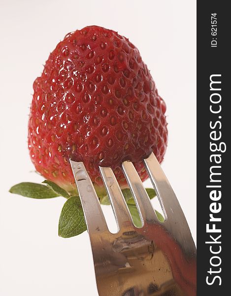 Strawberry on fork macro. Strawberry on fork macro