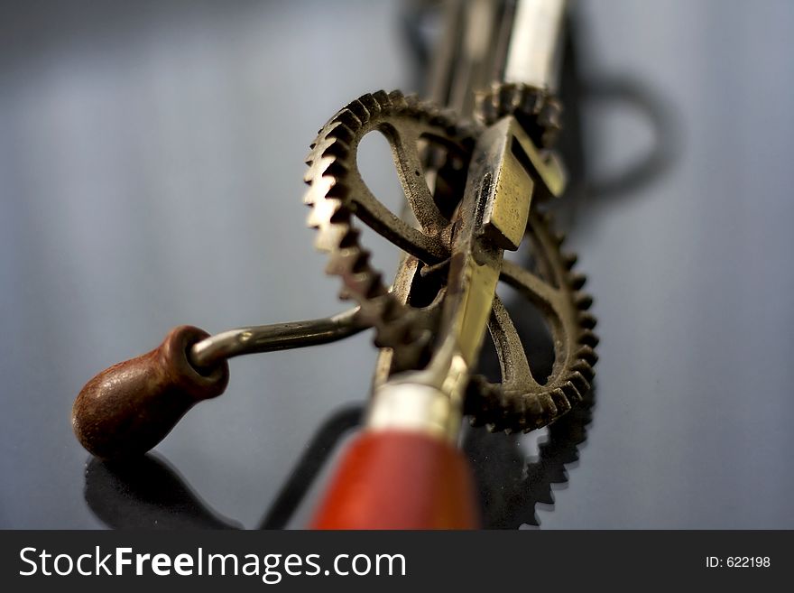 A vintage tool to whisk your eggs. Shallow depth of field centred on the gearwheel. A vintage tool to whisk your eggs. Shallow depth of field centred on the gearwheel.